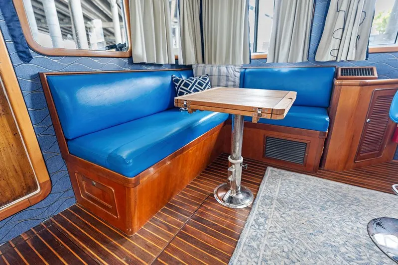  Yacht Photos Pics Interior of 2000 Selene Solo boat with blue seating and wooden table.