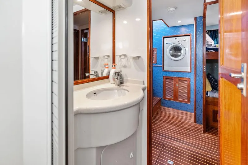  Yacht Photos Pics Bathroom and laundry area inside a 2000 Selene Solo yacht, featuring a sink and washing machine.