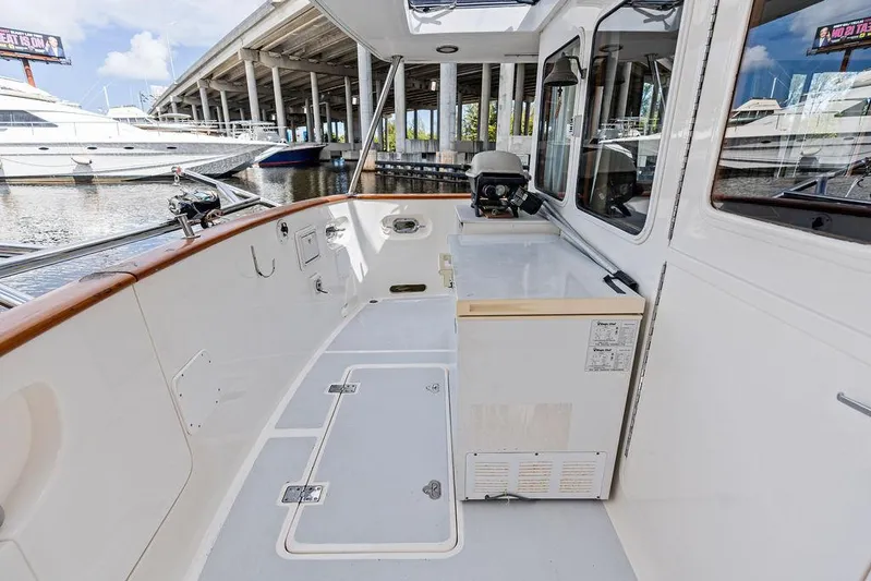  Yacht Photos Pics Selene Solo 2000 yacht deck with white finish, docked near other boats.