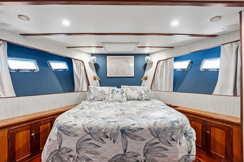  Yacht Photos Pics Cozy bedroom in 2000 Selene Solo yacht with nautical decor and elegant wood finishes.