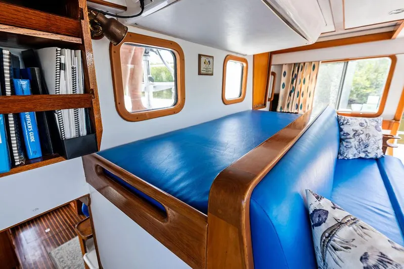  Yacht Photos Pics Cozy cabin interior of 2000 Selene Solo yacht with blue seating and wooden accents.