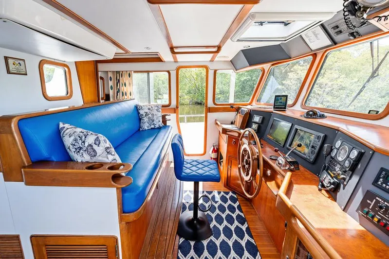  Yacht Photos Pics Luxurious Selene Solo 2000 yacht interior with blue seating, wooden accents, and advanced navigation equipment.