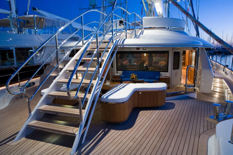Tamsen Yacht Photos Pics Luxurious 2007 Perini Navi 52M yacht deck with elegant seating and staircase at dusk.
