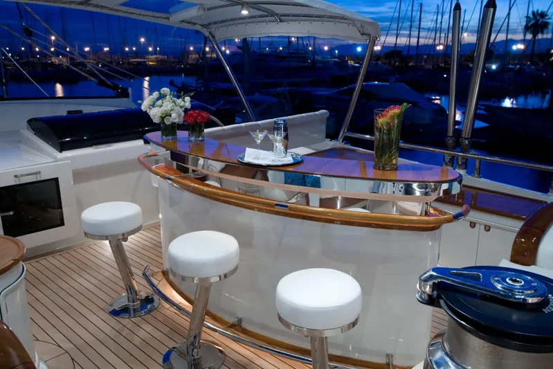 Tamsen Yacht Photos Pics Luxurious yacht bar area on 2007 Perini Navi 52M, featuring elegant seating and floral decor.
