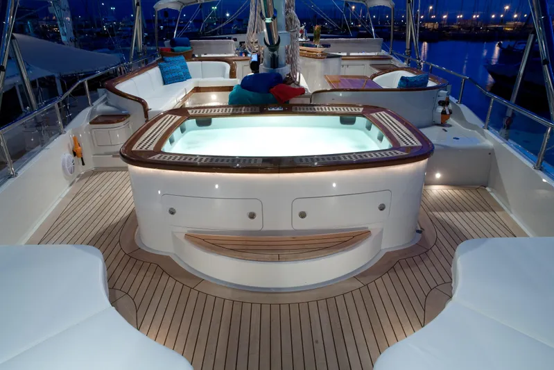 Tamsen Yacht Photos Pics Luxurious 2007 Perini Navi 52M yacht deck with illuminated jacuzzi and elegant seating.