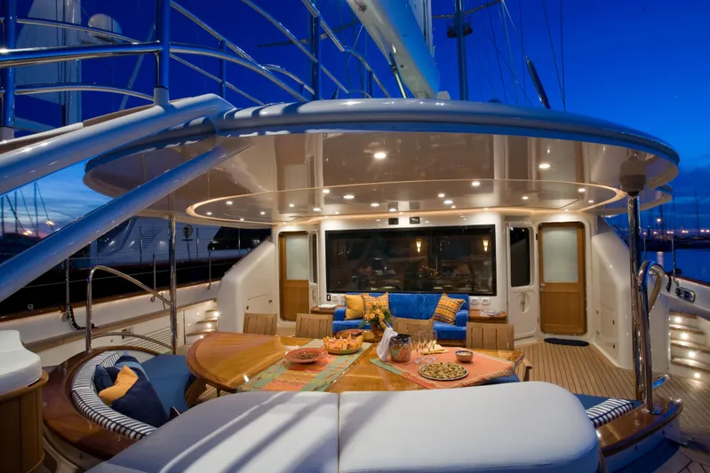 Tamsen Yacht Photos Pics Luxurious 2007 Perini Navi 52M yacht deck with elegant dining area at sunset.