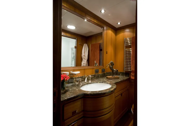 Tamsen Yacht Photos Pics Luxurious bathroom on 2007 Perini Navi 52M yacht with marble countertop and elegant wood finishes.