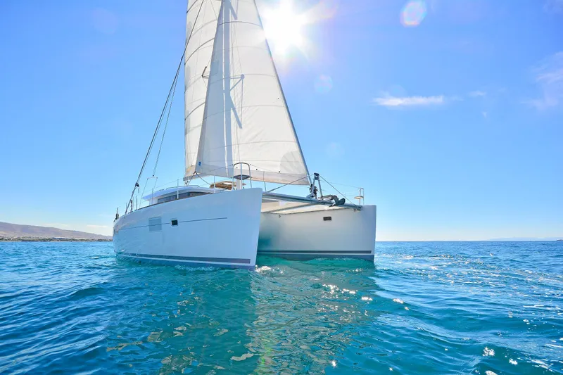  Yacht Photos Pics 2017 Lagoon 400 S2 catamaran sailing on clear blue ocean under sunny sky.