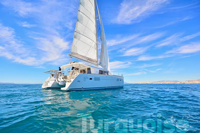  Yacht Photos Pics 2017 Lagoon 400 S2 catamaran sailing on clear blue ocean under vibrant sky.