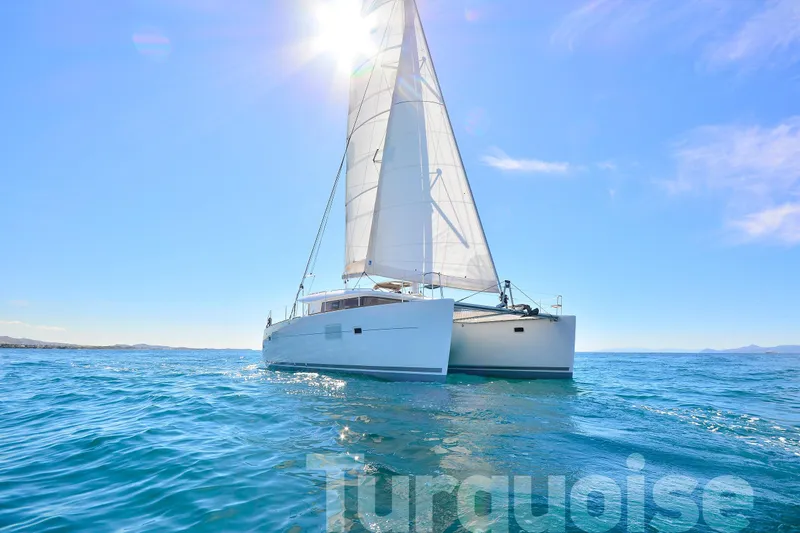  Yacht Photos Pics 2017 Lagoon 400 S2 catamaran sailing on clear blue ocean under bright sun.