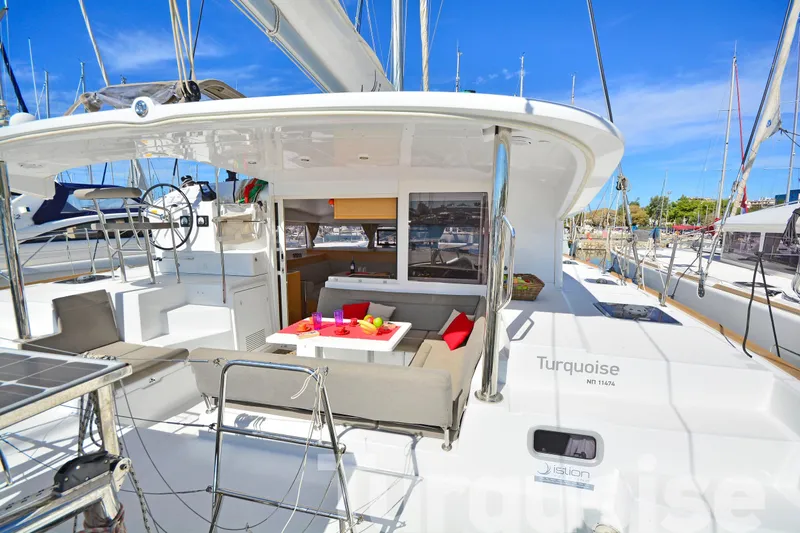  Yacht Photos Pics 2017 Lagoon 400 S2 catamaran with outdoor seating, docked in a sunny marina.