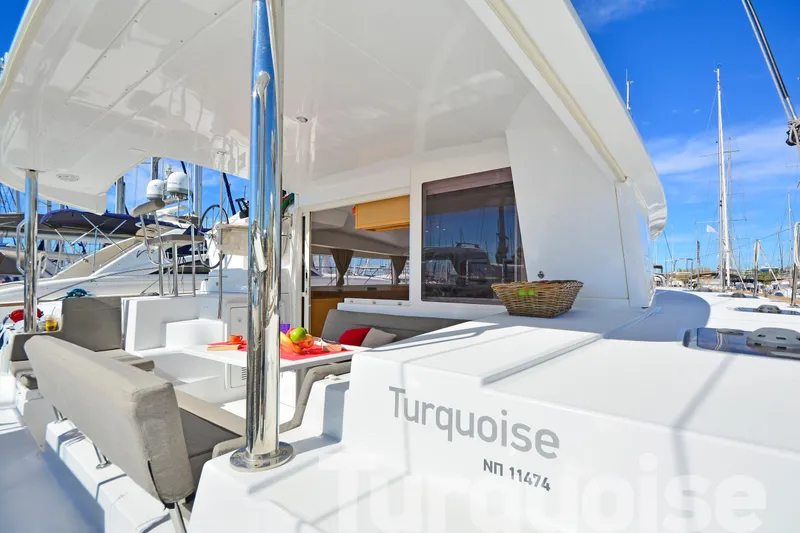  Yacht Photos Pics 2017 Lagoon 400 S2 catamaran with outdoor seating and fruit basket, docked in marina.
