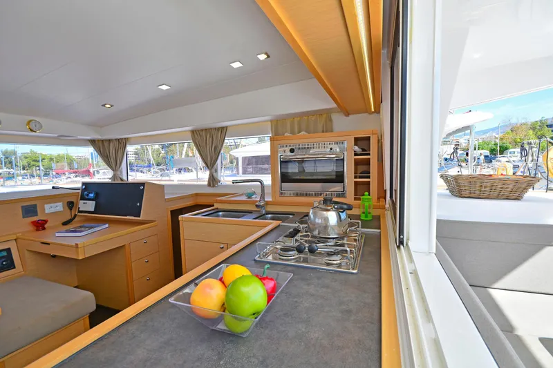  Yacht Photos Pics Interior of 2017 Lagoon 400 S2 yacht kitchen with stove, oven, and fruit bowl.