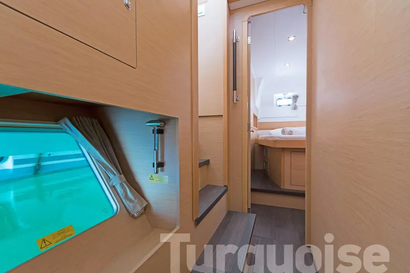 Yacht Photos Pics Interior of 2017 Lagoon 400 S2 yacht, featuring wooden finishes and a cozy cabin.