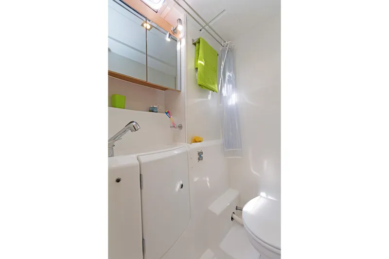  Yacht Photos Pics Compact bathroom in 2017 Lagoon 400 S2 yacht with modern fixtures and bright accents.