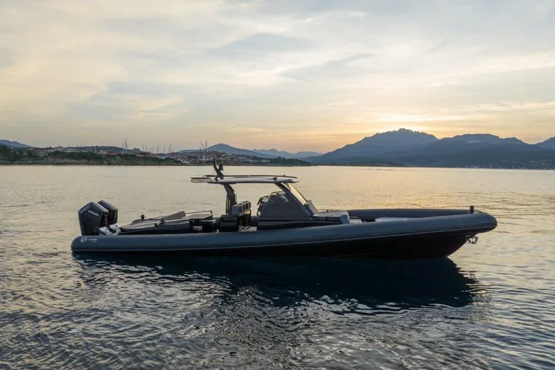  Yacht Photos Pics 2026 G-Tender DIECI4 boat on calm water at sunset, scenic mountain backdrop.