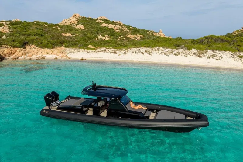  Yacht Photos Pics 2026 G-Tender DIECI4 boat in turquoise waters near a sandy beach.