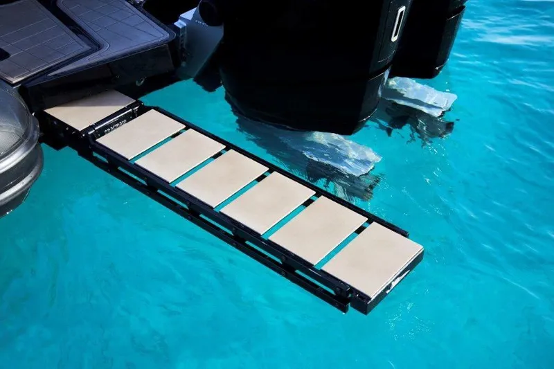  Yacht Photos Pics Retractable boat ladder on G-Tender DIECI4, 2026 model, over clear blue water.