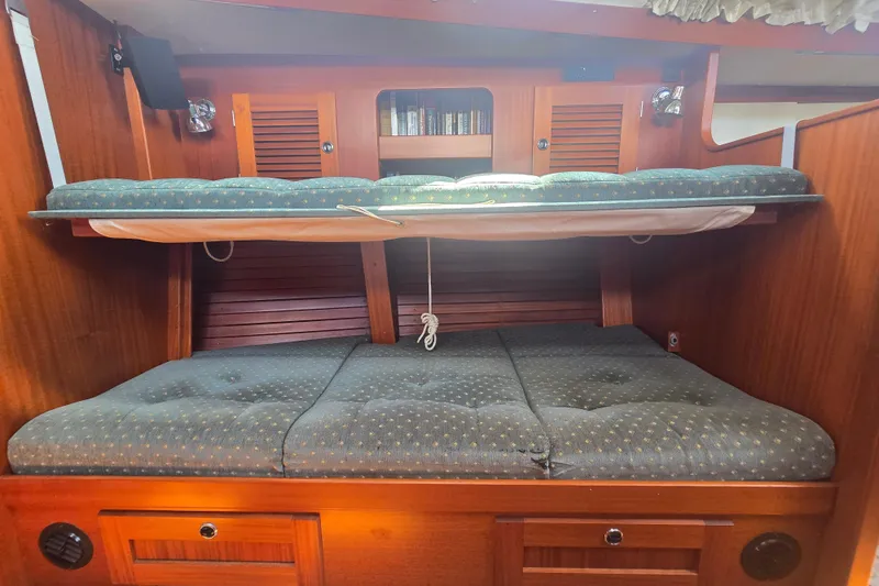 Georgia B Yacht Photos Pics Cozy cabin interior of 2000 Hallberg-Rassy 42F Mk II sailboat with bunk beds.