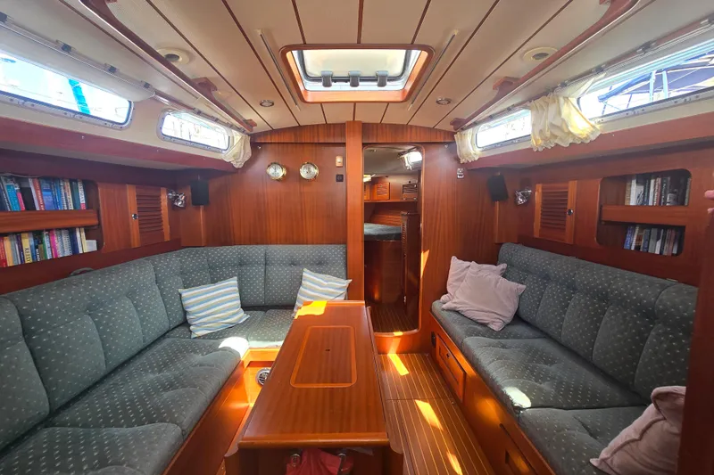 Georgia B Yacht Photos Pics Luxurious interior of 2000 Hallberg-Rassy 42F Mk II yacht with cozy seating and wooden finishes.