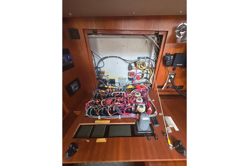 Georgia B Yacht Photos Pics Electrical panel of 2000 Hallberg-Rassy 42F Mk II yacht, showcasing intricate wiring and components.