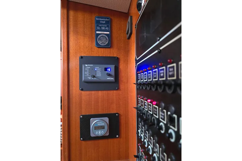 Georgia B Yacht Photos Pics Control panel inside a 2000 Hallberg-Rassy 42F Mk II yacht, featuring various switches and displays.