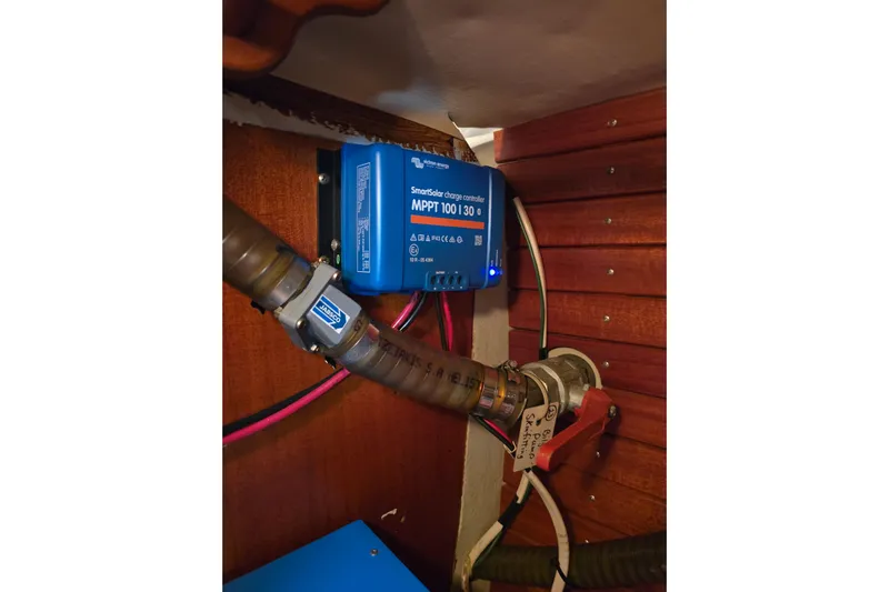 Georgia B Yacht Photos Pics MPPT charge controller in 2000 Hallberg-Rassy 42F Mk II yacht, mounted on wooden panel.