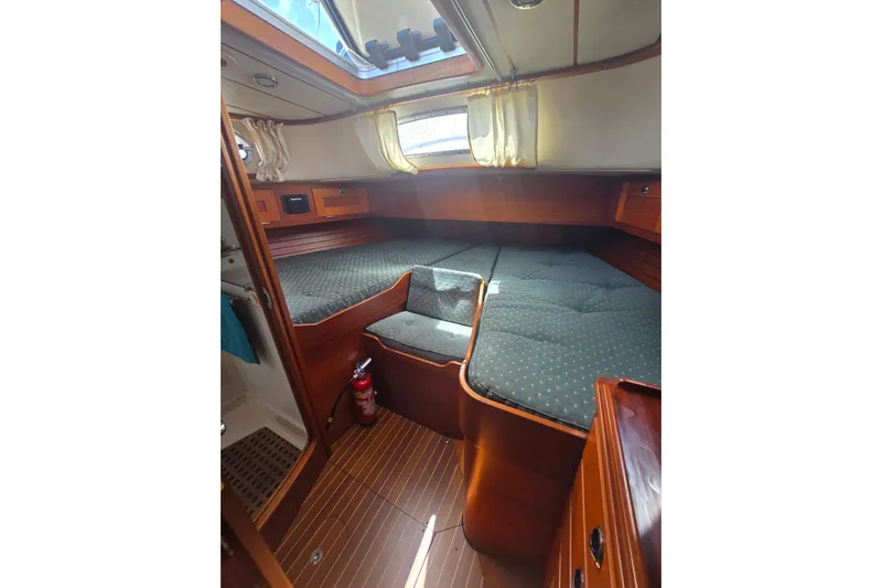 Georgia B Yacht Photos Pics Cozy cabin interior of 2000 Hallberg-Rassy 42F Mk II sailboat with wooden finish and skylight.