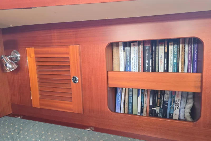 Georgia B Yacht Photos Pics Wooden interior of 2000 Hallberg-Rassy 42F Mk II with bookshelf and reading light.