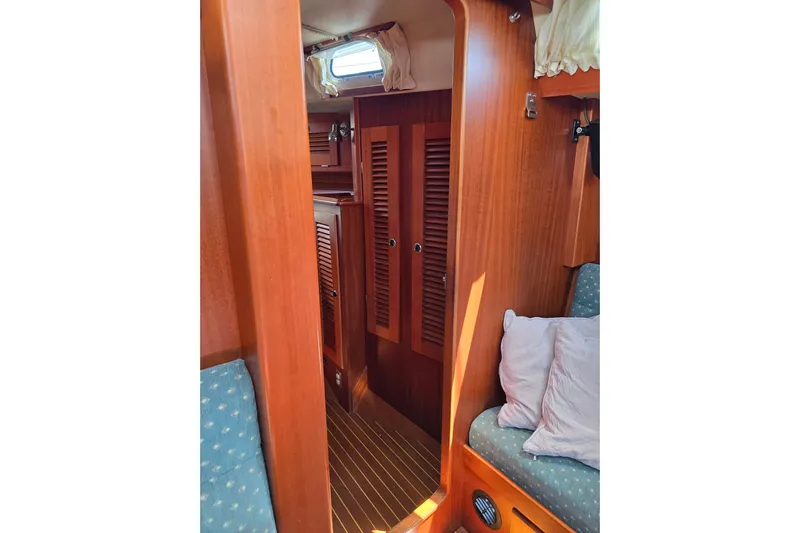 Georgia B Yacht Photos Pics Interior of 2000 Hallberg-Rassy 42F Mk II yacht with wooden finish and cozy seating.
