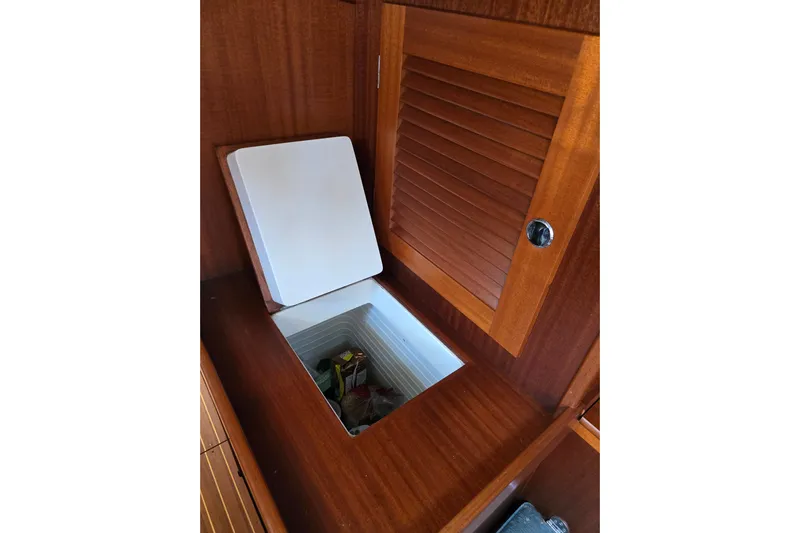 Georgia B Yacht Photos Pics Open storage compartment on Hallberg-Rassy 42F Mk II yacht, showcasing wooden interior, 2000 model.
