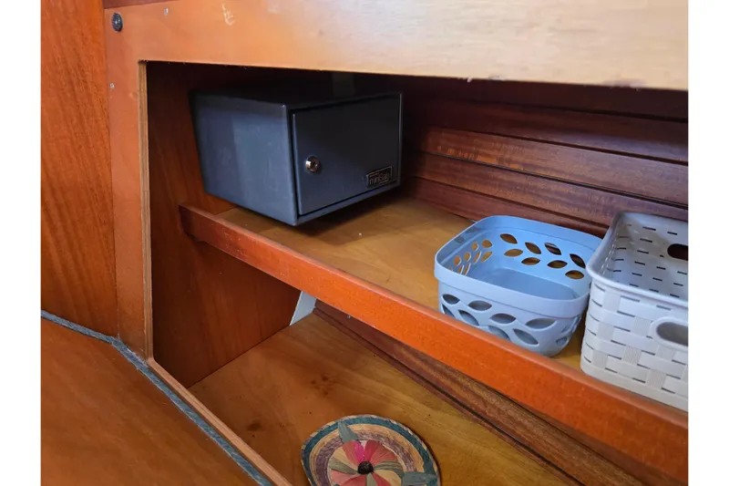 Georgia B Yacht Photos Pics Wooden cabinet interior on a 2000 Hallberg-Rassy 42F Mk II yacht with storage baskets.