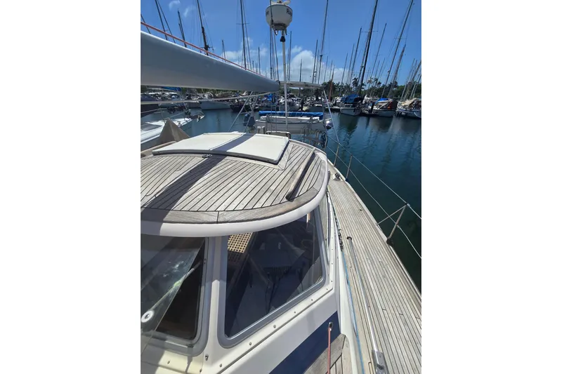 Georgia B Yacht Photos Pics Sailboat Hallberg-Rassy 42F Mk II, 2000 model, docked in a marina with clear skies.