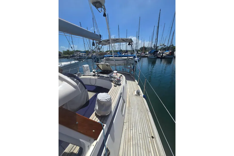 Georgia B Yacht Photos Pics Sailboat Hallberg-Rassy 42F Mk II, 2000 model, docked in a marina under clear skies.