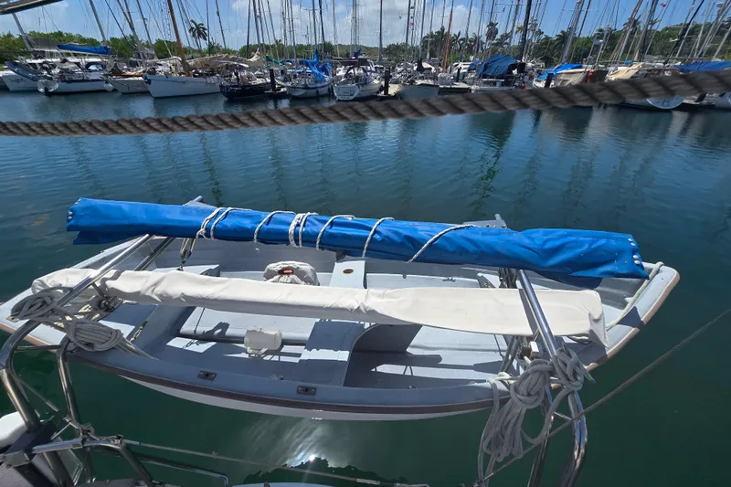 Georgia B Yacht Photos Pics Hallberg-Rassy 42F Mk II sailboat docked in marina, 2000 model, with dinghy on deck.
