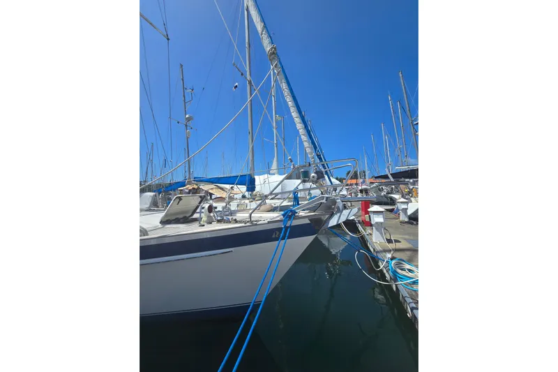 Georgia B Yacht Photos Pics Sailboat Hallberg-Rassy 42F Mk II, 2000 model, docked in a marina under clear blue sky.