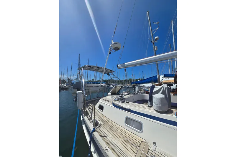 Georgia B Yacht Photos Pics Hallberg-Rassy 42F Mk II sailboat, 2000 model, docked in a sunny marina.