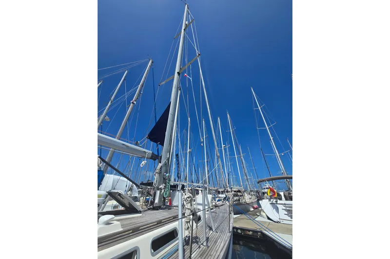 Georgia B Yacht Photos Pics Sailboats docked at marina, featuring 2000 Hallberg-Rassy 42F Mk II under clear blue sky.