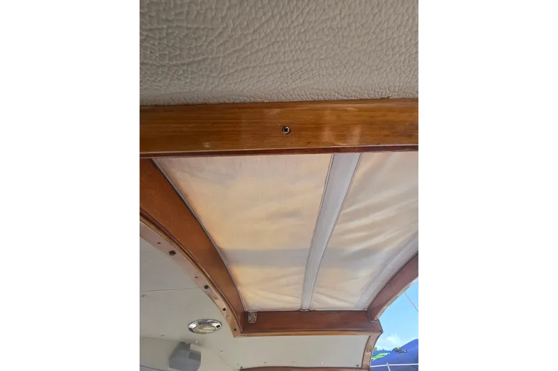 Georgia B Yacht Photos Pics Interior ceiling of 2000 Hallberg-Rassy 42F Mk II yacht with wooden trim and fabric panel.