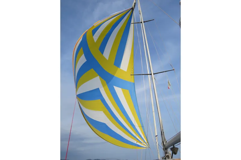 Georgia B Yacht Photos Pics Colorful spinnaker sail on 2000 Hallberg-Rassy 42F Mk II yacht against blue sky.