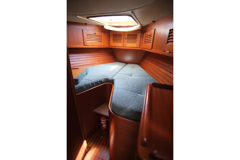 Georgia B Yacht Photos Pics Cozy cabin interior of 2000 Hallberg-Rassy 42F Mk II sailboat with wooden finish.