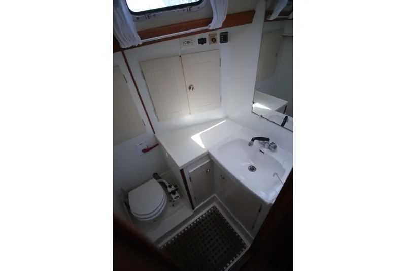 Georgia B Yacht Photos Pics Bathroom interior of 2000 Hallberg-Rassy 42F Mk II yacht, featuring sink and toilet.