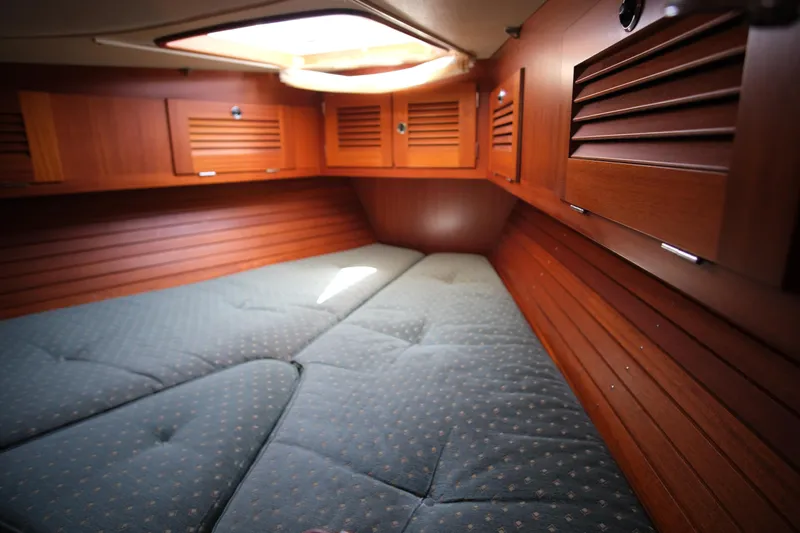 Georgia B Yacht Photos Pics Cozy cabin interior of 2000 Hallberg-Rassy 42F Mk II sailboat with wooden paneling.