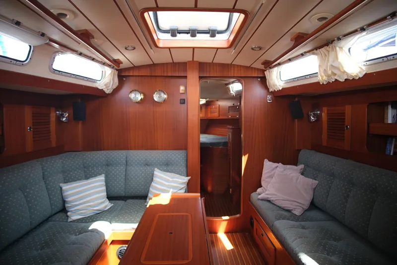 Georgia B Yacht Photos Pics Interior of 2000 Hallberg-Rassy 42F Mk II yacht with cozy seating and wooden finish.