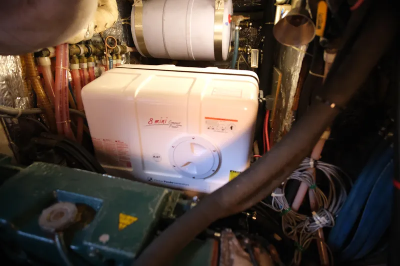 Georgia B Yacht Photos Pics Engine room of 2000 Hallberg-Rassy 42F Mk II with compact water heater.