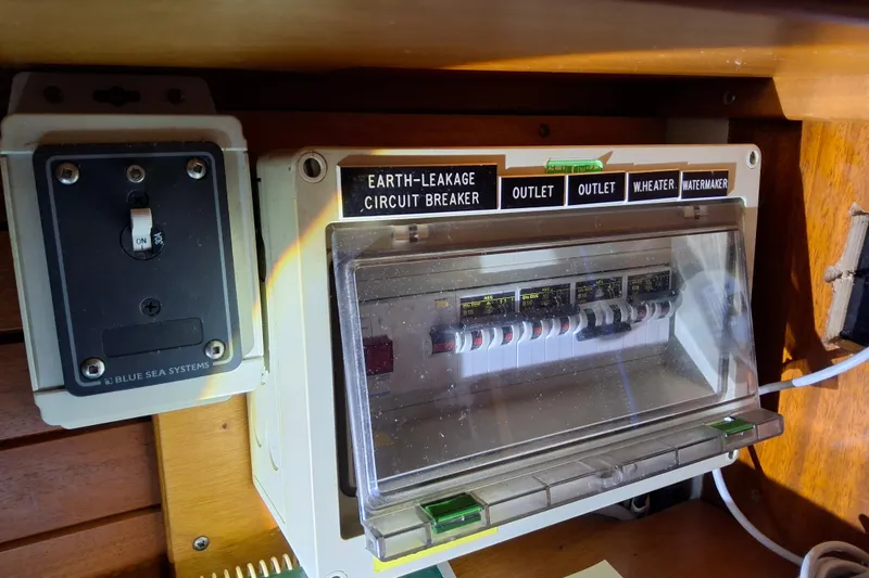 Georgia B Yacht Photos Pics Electrical panel on a 2000 Hallberg-Rassy 42F Mk II yacht, featuring circuit breakers.