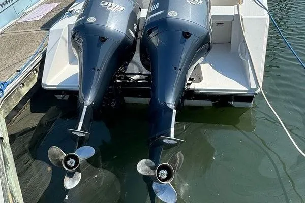 Lady Michelle Yacht Photos Pics Twin outboard engines on a 2012 Jupiter 29 FS CC boat, docked in water.