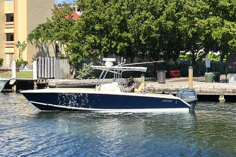 Lady Michelle Yacht Photos Pics 2012 Jupiter 29 FS CC boat on water near dock, surrounded by trees.