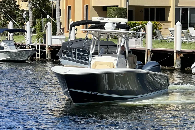 Lady Michelle Yacht Photos Pics 2012 Jupiter 29 FS CC boat cruising on a sunny waterfront near docks.