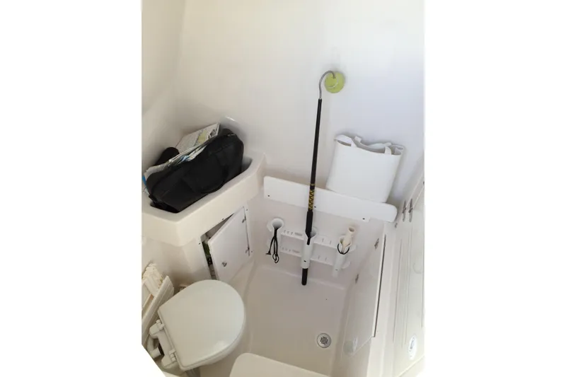 Lady Michelle Yacht Photos Pics Interior of 2012 Jupiter 29 FS CC boat, featuring compact storage and toilet area.